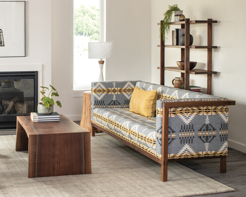 Sebastian Tall Bookcase in Eastern Walnut with Celilo Sofa and Live-Edge miter wrap coffee table