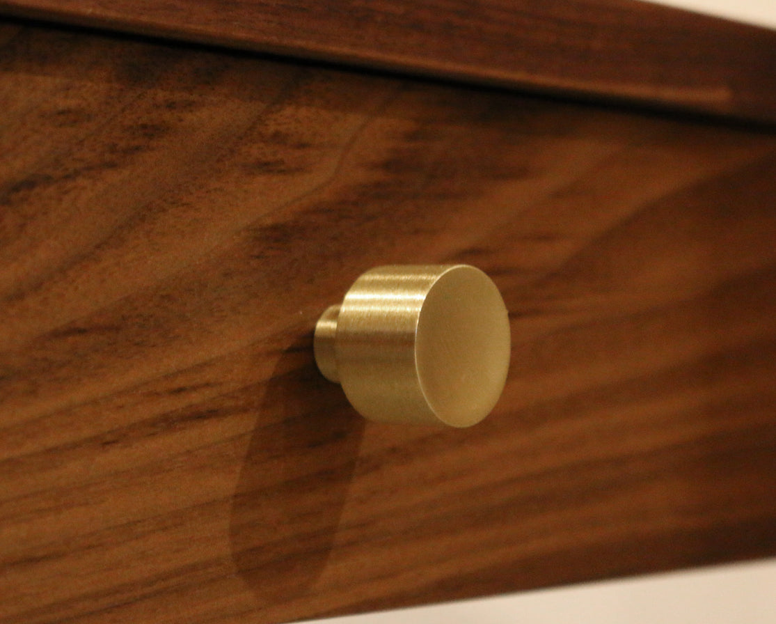 Brushed brass Maud knob on Eastern Walnut drawer front