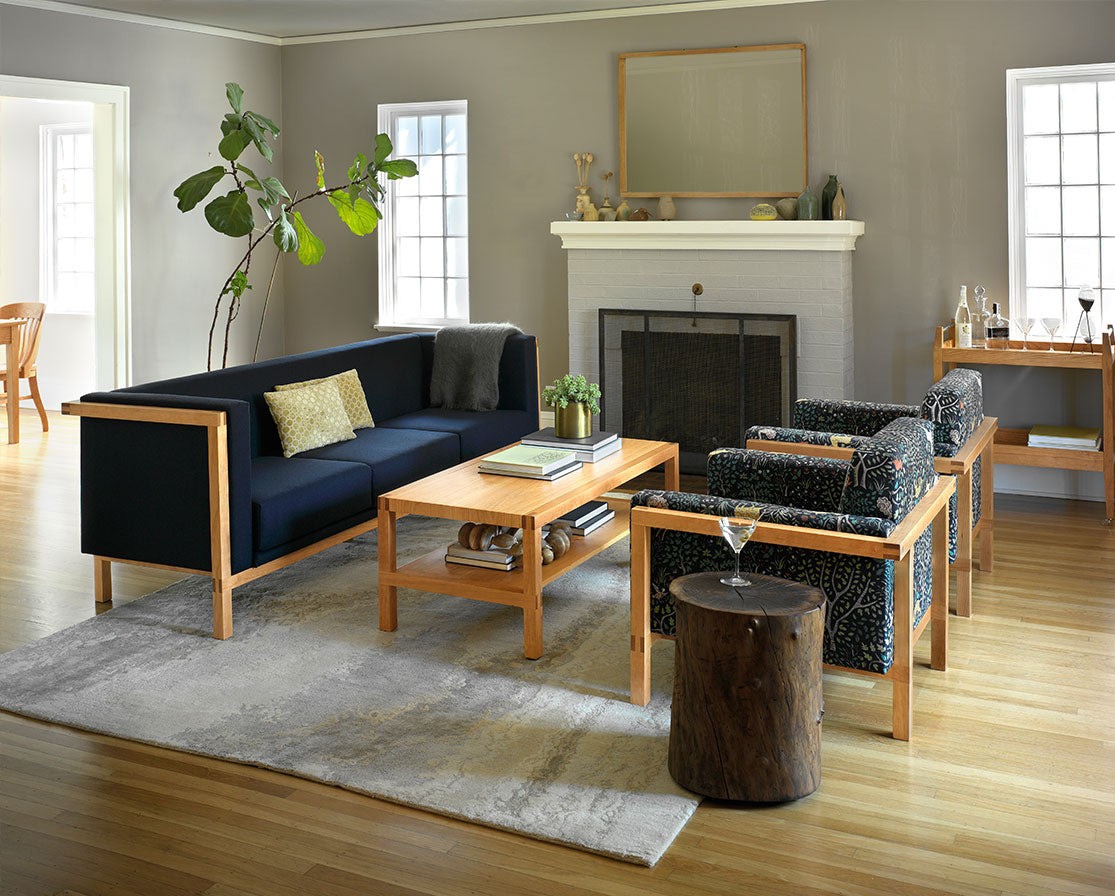 Celilo Coffee Table in Cherry with Celilo Sofa and Lounge Chairs.