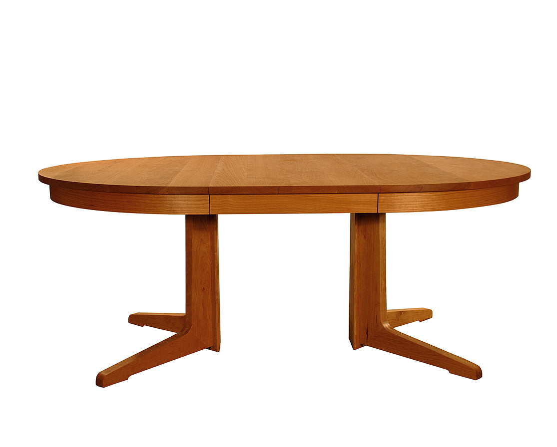 Contemporary Round Pedestal Dining Table in Cherry, shown with one leaf