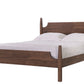 A dark brown wooden bed frame with a curved headboard and footboard, shown with white bedding and two pillows against a solid white background.