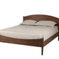 A classic wooden bed frame with a curved headboard and footboard, shown with light beige bedding and two pillows on a solid white background.
