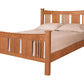 A traditional bed with slats and panels made with Cherry wood frame and headboard, dressed in white bedding and two white pillows, shown against a plain white background.