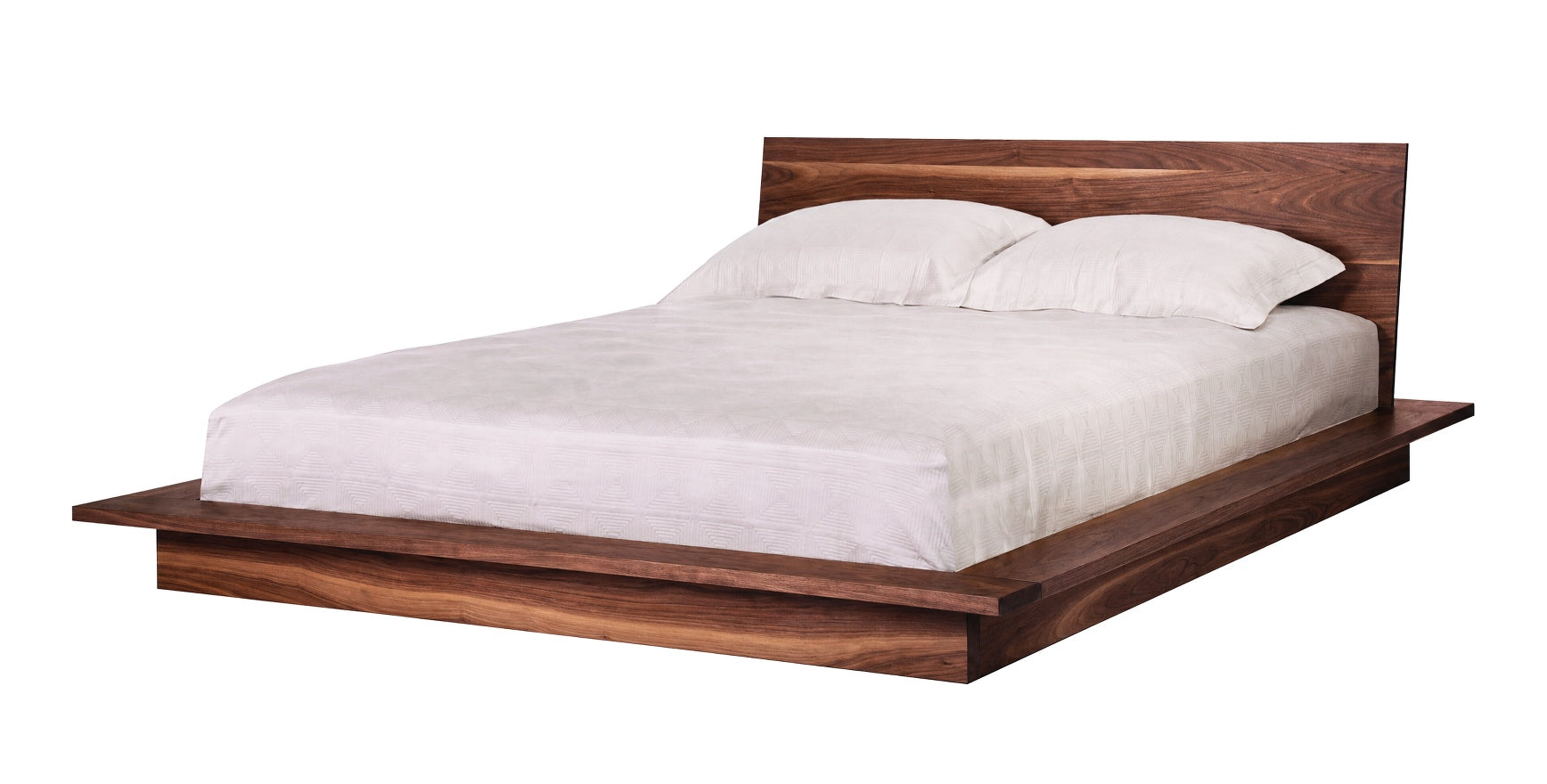 A modern low-profile platform bed with a dark Walnutwood frame and headboard, dressed in white bedding and two white pillows, shown against a plain white background.