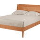 A mid-century modern wooden bed frame with a warm oak finish, shown with a light beige sheet and two pillows against a solid white background.