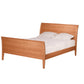 A light Cherry wood bed frame with a curved headboard and footboard, shown with white bedding and two pillows on a solid white background.