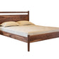 A dark Walnut wood bed frame with a matching headboard and footboard, shown with a mattress and two pillows on a plain white background.