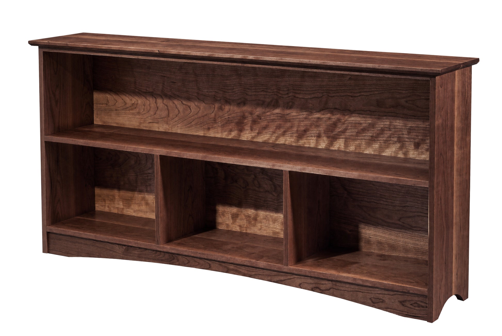 A dark brown wooden bookcase with three open shelves and a curved bottom edge, shown against a plain white background.