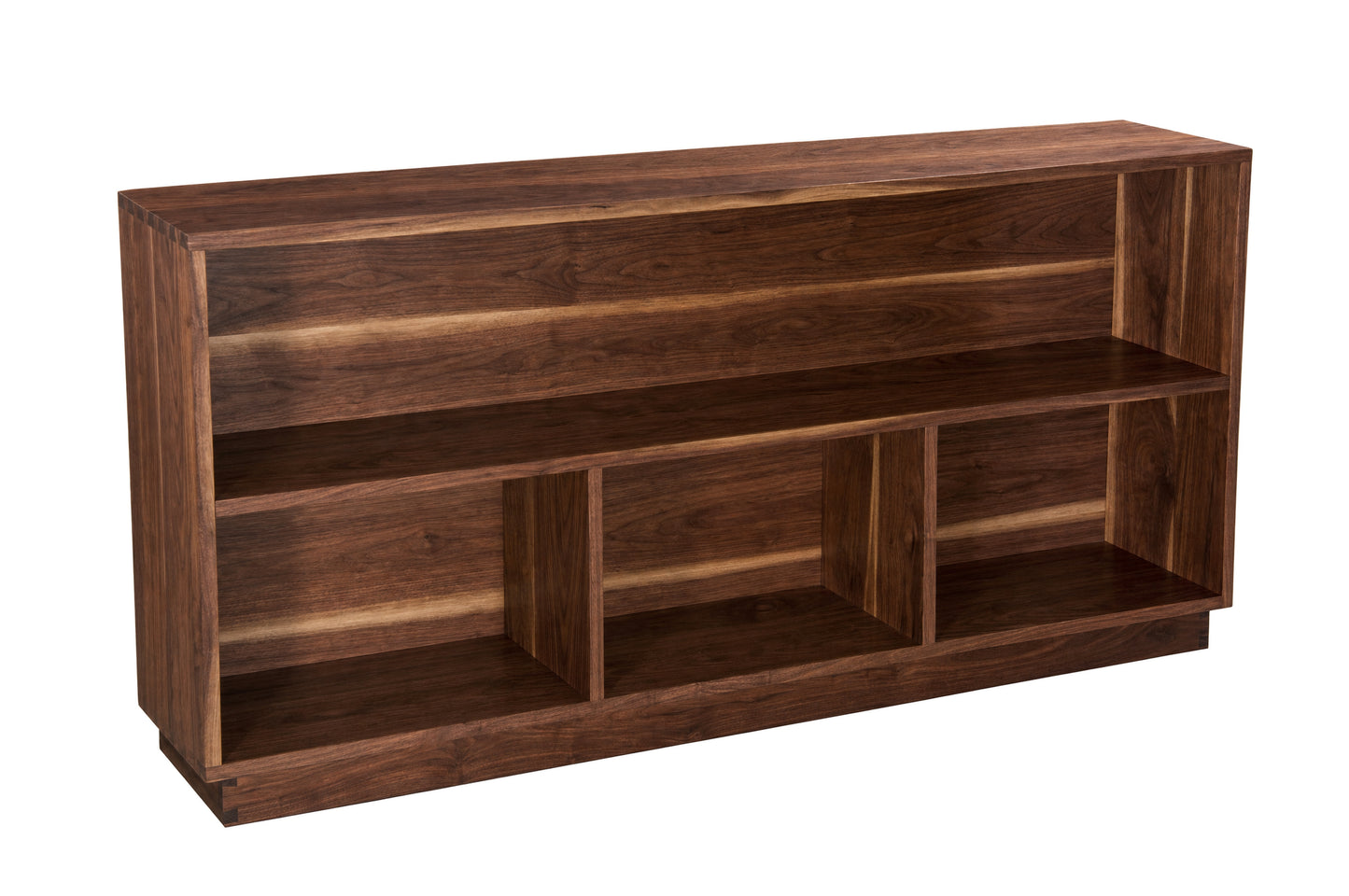 A dark brown wooden bookcase with three open shelves and a slanted top, shown from a three-quarter angle on a white background.