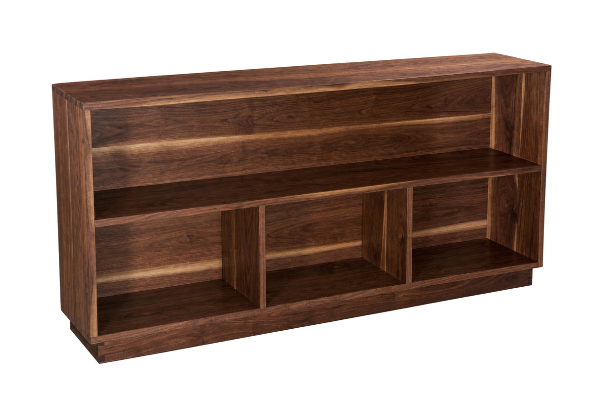 A dark brown wooden bookcase with three open shelves and a slanted top, shown from a three-quarter angle on a white background.