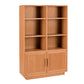 A tall wooden bookcase with a warm Cherry finish, featuring six open shelves on the upper section and two cabinet doors on the lower section, shown against a plain white background.