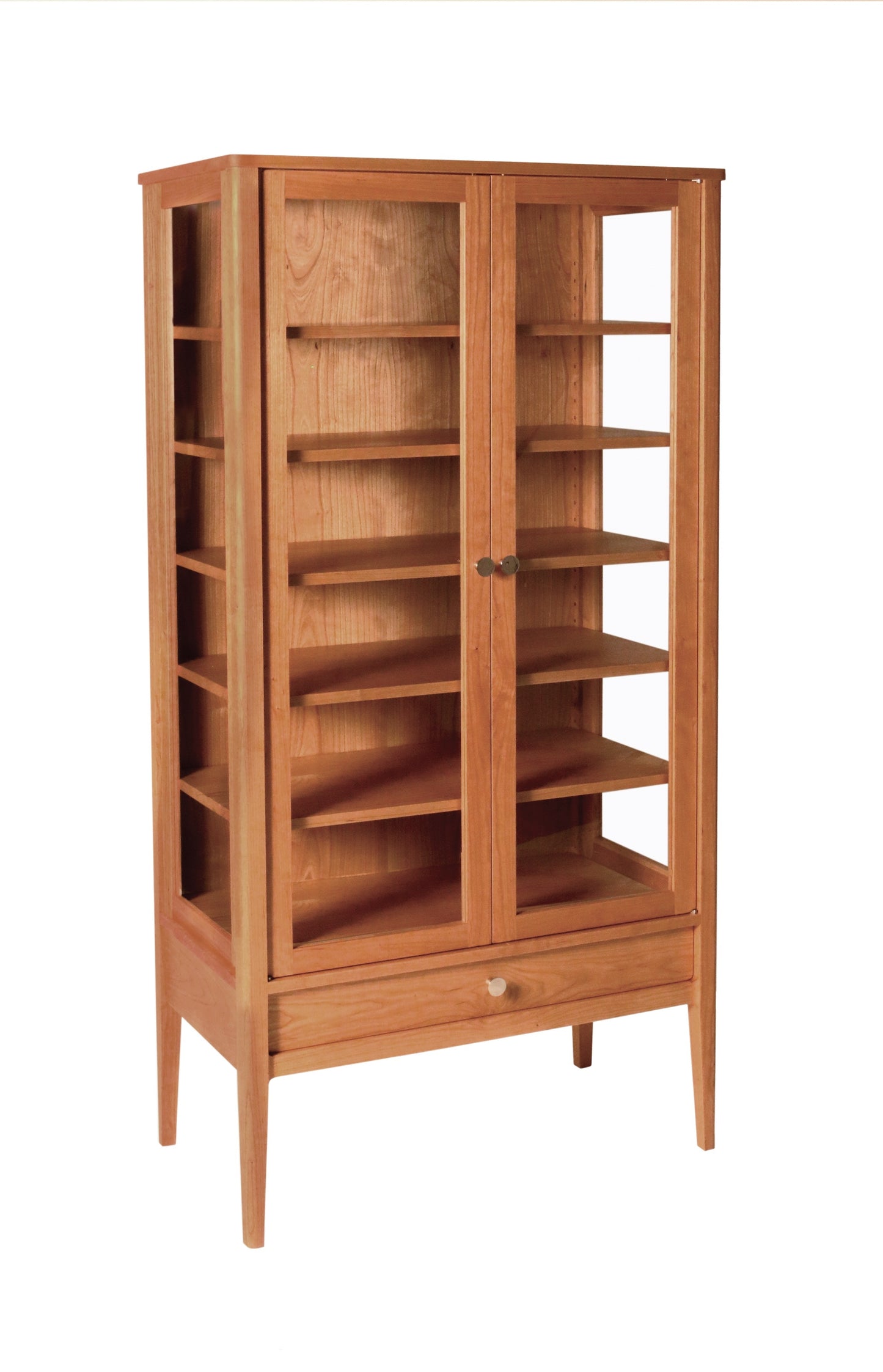 A mid-century modern wooden display cabinet with glass doors, multiple interior shelves, and a single drawer at the bottom, shown on a plain white background.
