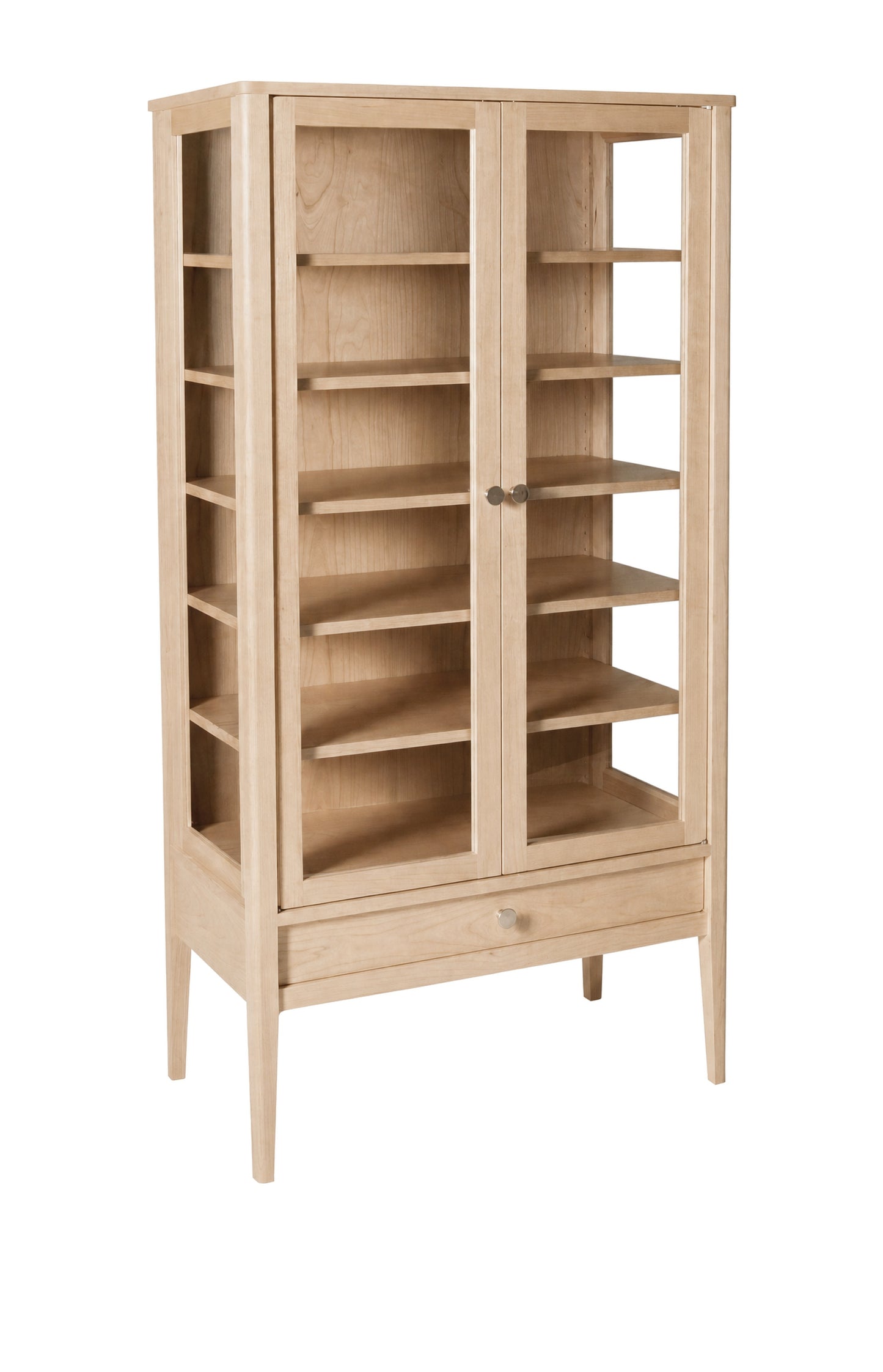 A tall, light natural oak wooden bookcase with two glass doors, multiple interior shelves, and a single drawer at the bottom, shown on a plain white background.