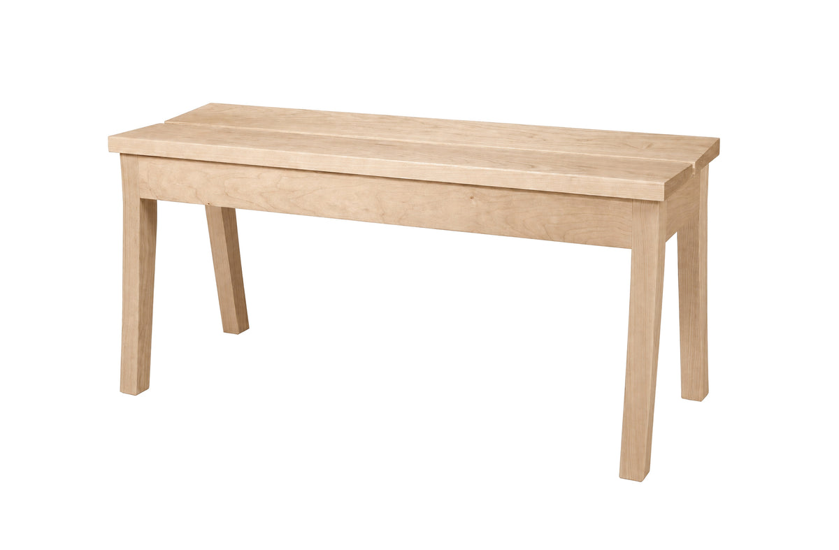 A light natural wood bench with a rectangular top and four legs, shown from a three-quarter angle on a solid white background.