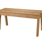 A light oak wood bench with a rectangular top and four legs, shown from a three-quarter angle on a solid white background.