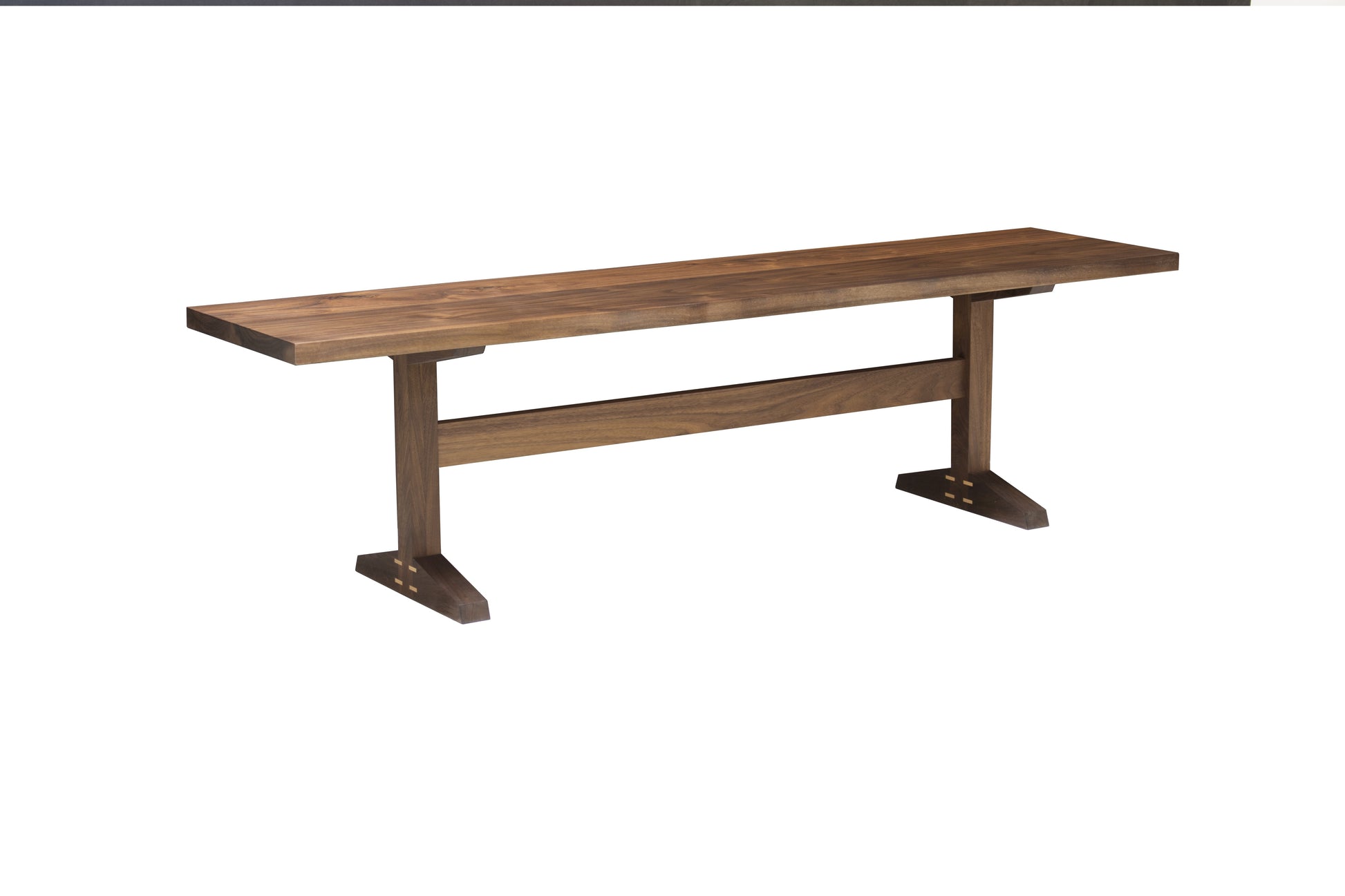 A rustic wooden dining bench with a medium brown wood grain finish, featuring a thick rectangular seat and a sturdy support frame with angled feet, shown against a plain white background.