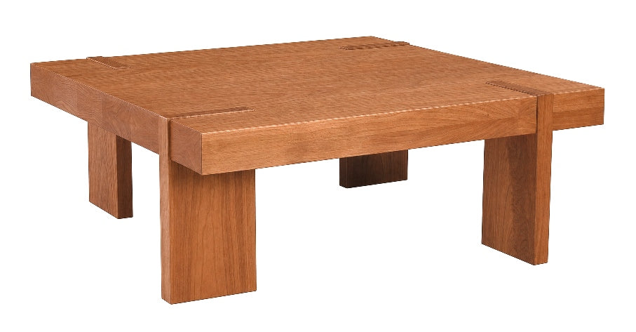 A low, square wooden table with thick block legs and visible wood grain, shown on a plain white background.