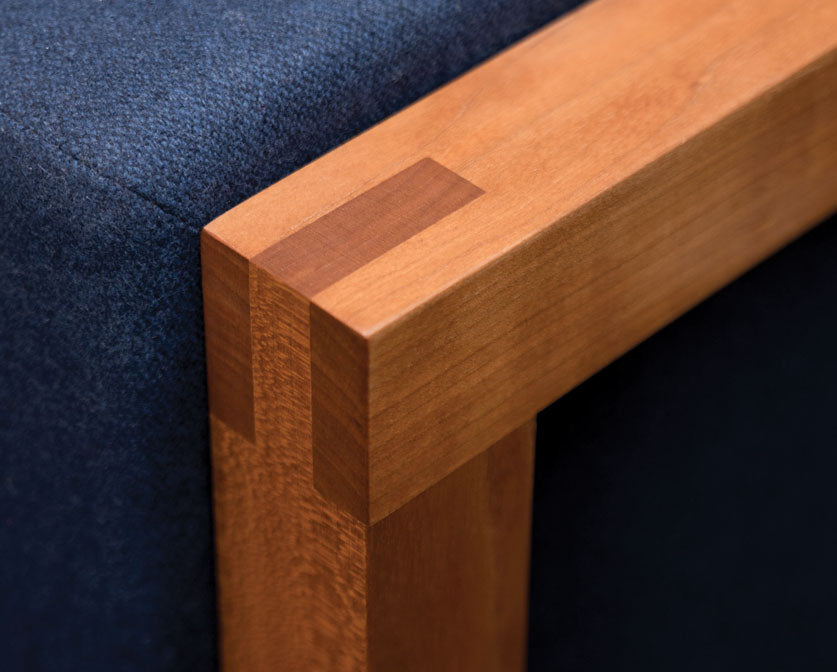 Detail of Celilo Lounge Chair arm in Cherry