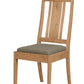 A wooden dining chair with a natural oak finish and a textured gray upholstered seat cushion, shown against a plain white background.