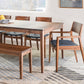 Dining room with wooden table and chairs on a striped rug