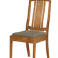 A wooden dining chair with a warm medium-brown wood frame and a textured gray upholstered seat cushion, shown against a plain white background.
