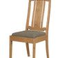 A wooden dining chair with a natural oak finish and a textured gray upholstered seat cushion, shown against a plain white background.