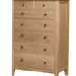Tall classic 7 drawer dresser in an Oak finish and metal square knobs on a white background.