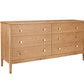 A mid-century modern six-drawer wooden dresser in an Oak finish, featuring small round brass knobs, shown on a solid white background.