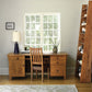 Wooden desk with chair in a home office setting with a bookshelf and window.