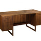 A mid-century modern walnut wood writing desk with three drawers on the left, two drawers on the right, an open center space, and a lower shelf, shown on a plain white background.