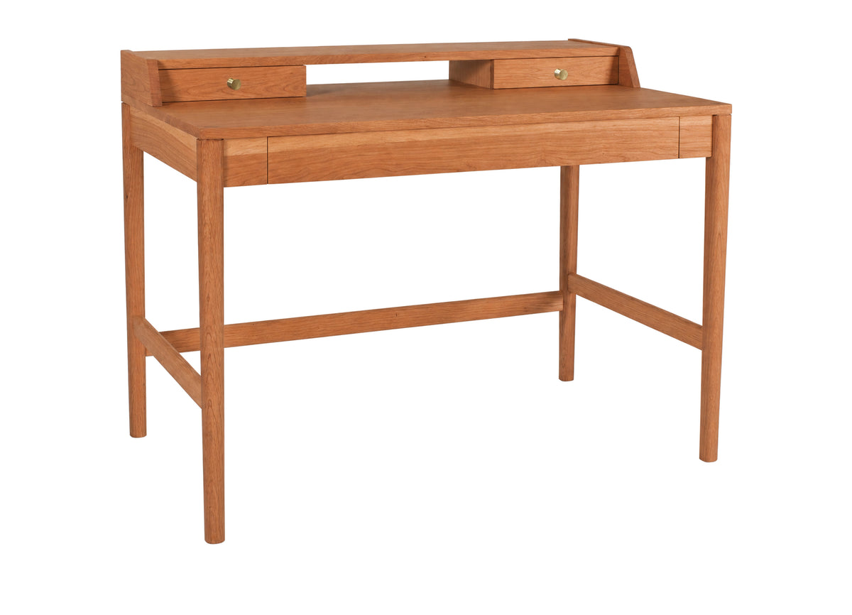 A mid-century modern wooden writing desk with a warm orange-brown finish, featuring a top shelf with two small drawers, a central drawer, and a lower support rail, shown on a plain white background.