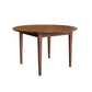 A round wooden dining table with a medium brown finish and four tapered legs, shown from a three-quarters angle on a solid white background.