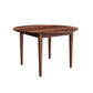 A round wooden dining table with a Walnut finish and four tapered legs, shown on a plain white background.