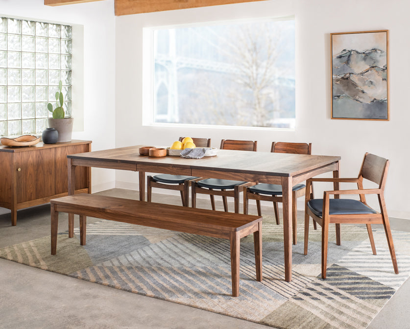 Whitman arm and side chairs with leather upholstery in Eastern Walnut with Whitman dining table, Whitman bench, and Whitman sideboard.