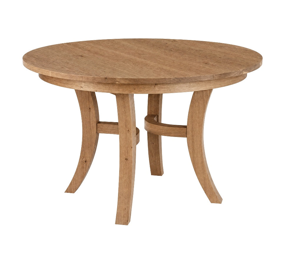A round wooden dining table with a natural oak finish, featuring curved legs and a central stretcher, shown on a plain white background.