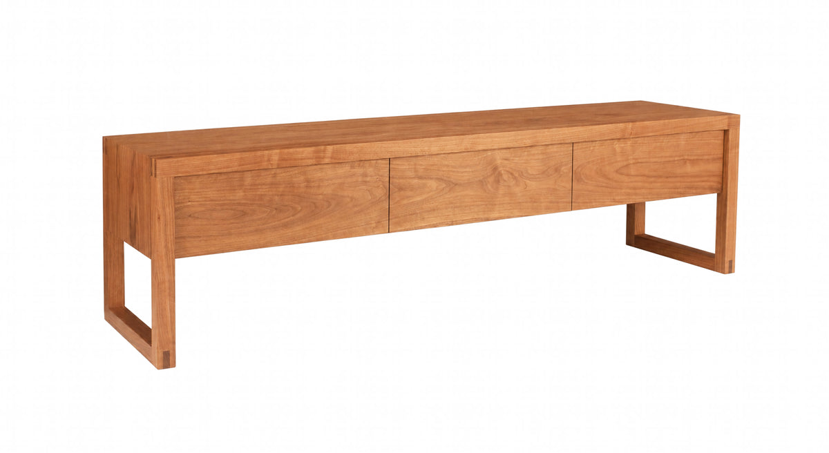 A Cherry modern wooden console table with three drawers and a minimalist frame, shown on a plain white background.