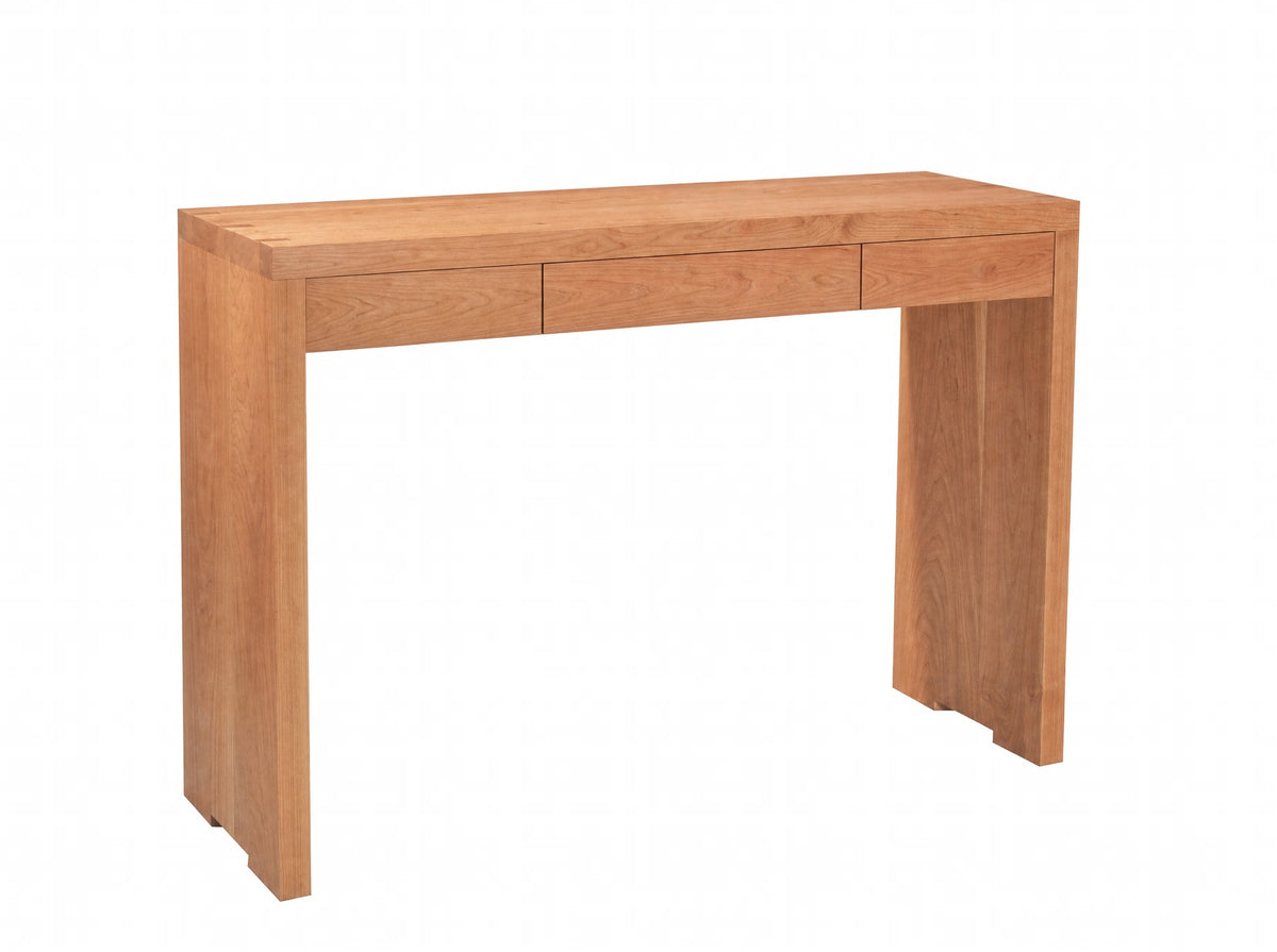 A light Cherry wood console table with three drawers on the front and a rectangular apron base, shown from a three-quarter angle on a white background.
