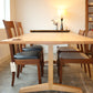 Wooden dining table with chairs in a room setting
