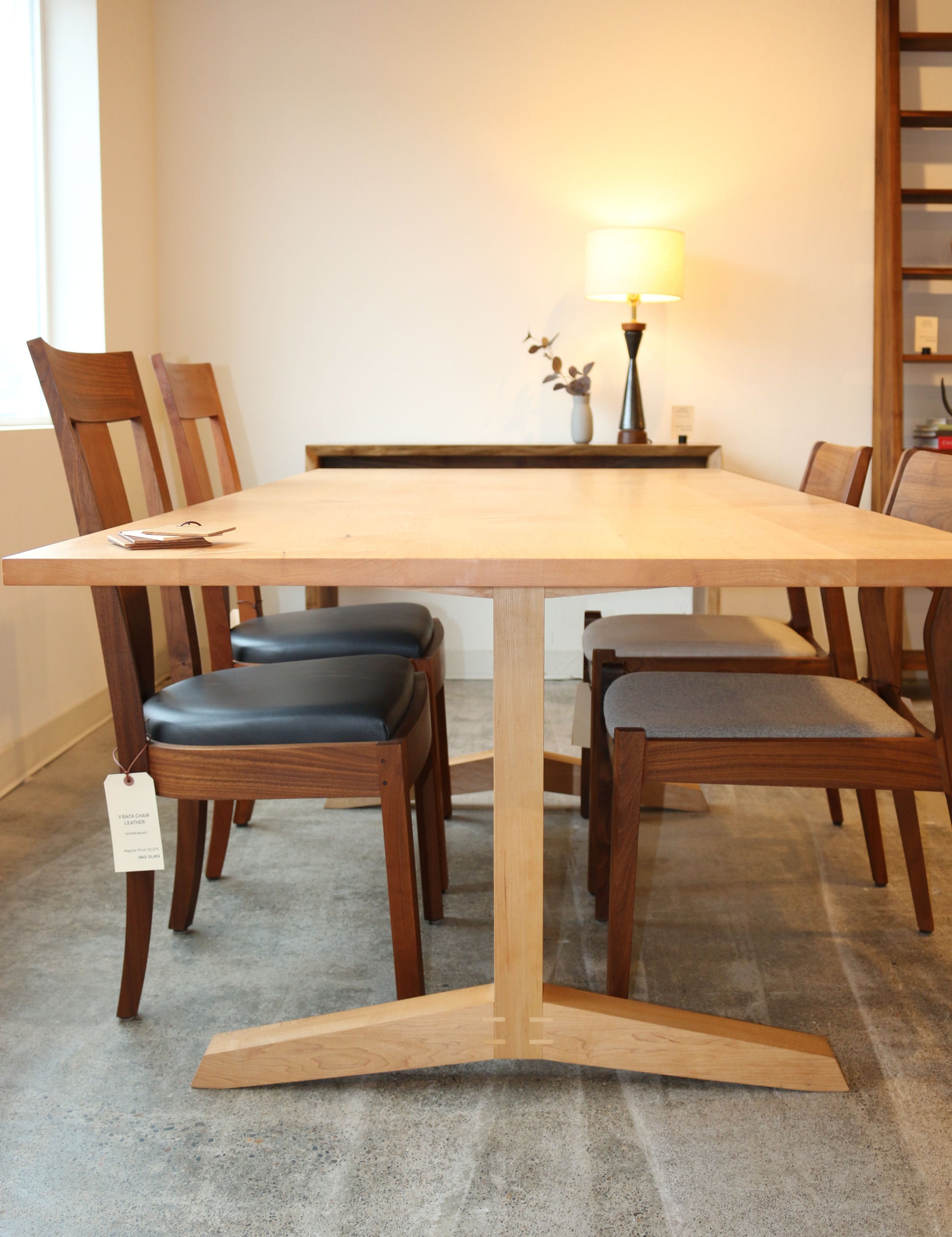 Wooden dining table with chairs in a room setting