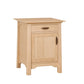 A light natural oak nightstand with a single drawer and one cabinet door, featuring dark wood handles, shown on a plain white background.