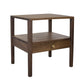 A dark brown wooden side table with a single drawer featuring a brass pull handle, set against a plain white background.