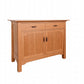 A Cherry wood sideboard cabinet with two drawers on top and two paneled doors below, featuring dark wood handles, shown on a plain white background.