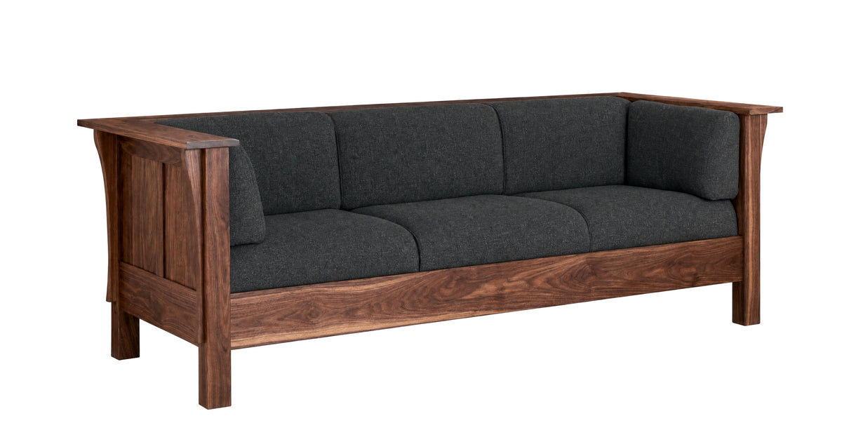 A three-seater wooden sofa with dark charcoal gray fabric cushions, featuring a rich walnut-like wood frame and armrests, shown against a plain white background.