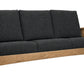 A wooden outdoor loveseat with dark charcoal gray textured cushions, featuring a natural oak frame and armrests, shown on a solid white background.