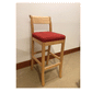 Wood stool with red cushion in a room