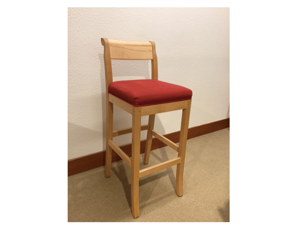 Wood stool with red cushion in a room