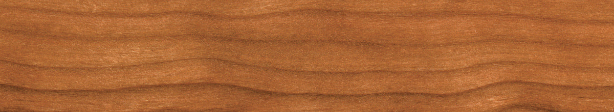 Close-up of a Cherry wood surface with a rich brown color and visible grain pattern.