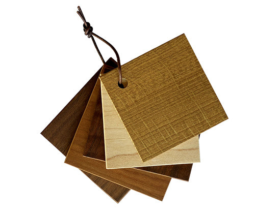 Set of wooden color swatches with a leather strap on a white background