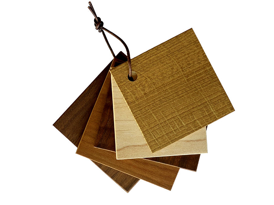 Set of wooden color swatches with a leather strap on a white background